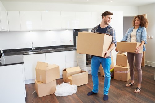 Packed moving boxes and furniture ready for collection in Wennington