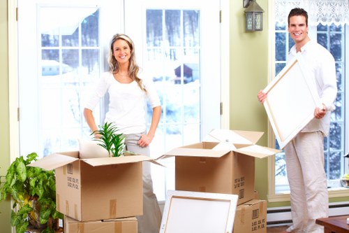 Careful wrapping of fragile household items during packing in Wennington