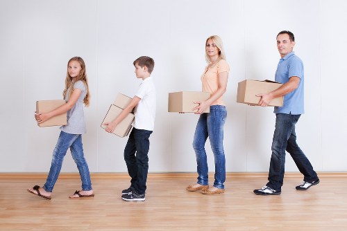 Professional movers handling furniture in a Wennington property