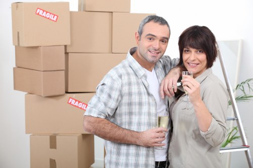 Crew carefully moving boxed household items with proper lifting technique